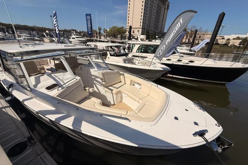 Slide: The Image of 2026 MJM 3 boat, top and side view, featuring sleek design and dual outboard engines. - 33