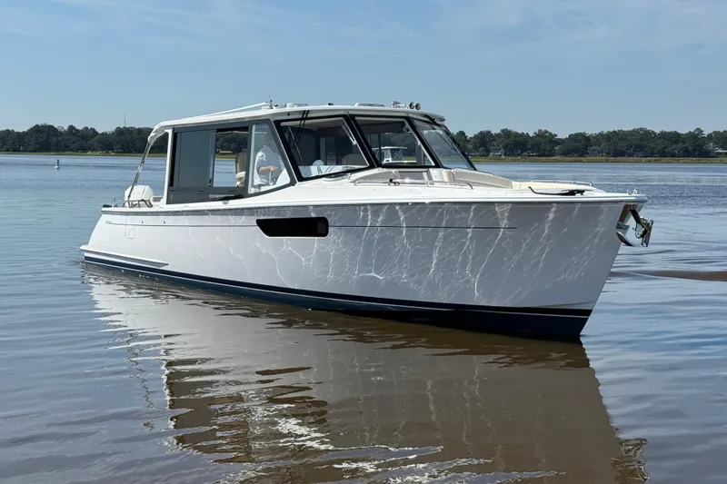 Slide: The Image of 2026 MJM 38x boat with Mercury outboard engines on calm water. - 4