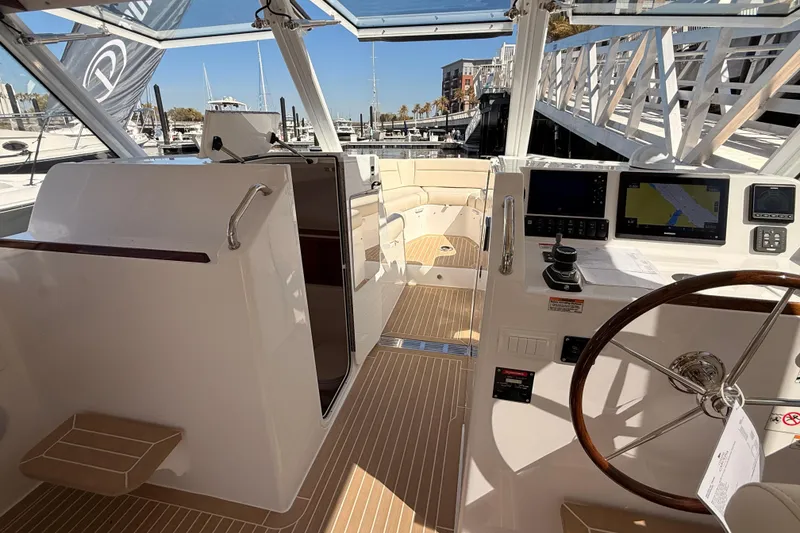 Slide: The Image of Control panel of 2026 MJM 38x boat, featuring switches and digital displays. - 48