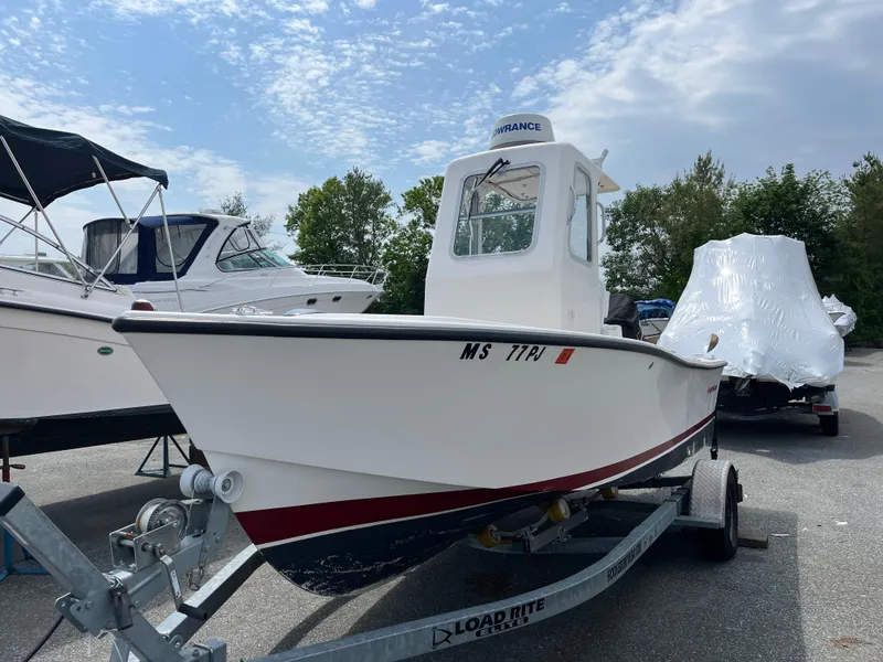 The Image of 2018 NorthCoast 190 Center Console boat on trailer, parked outdoors under cloudy sky. - 1
