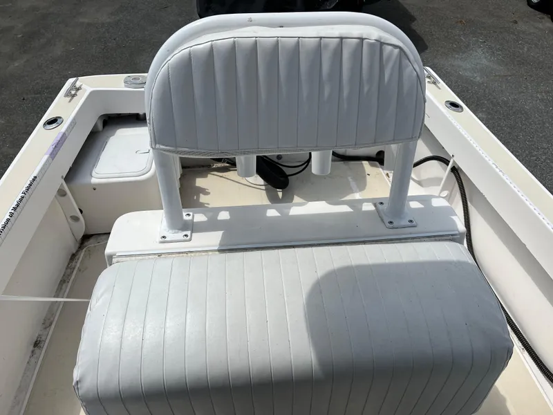 Slide: The Image of 2018 NorthCoast 190 Center Console boat seating area with white cushioned bench. - 10