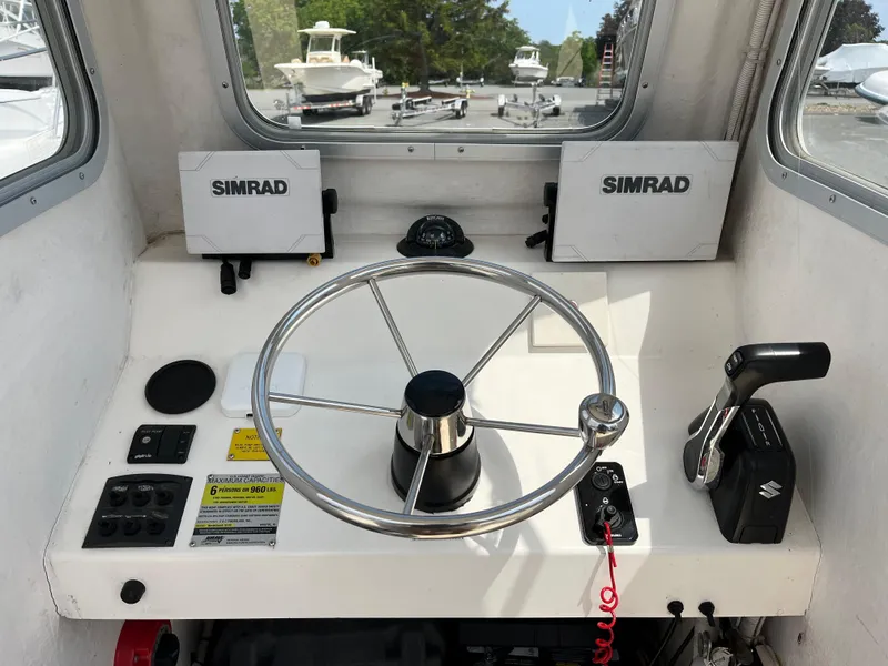 Slide: The Image of 2018 NorthCoast 190 Center Console boat helm with Simrad electronics and steering wheel. - 11