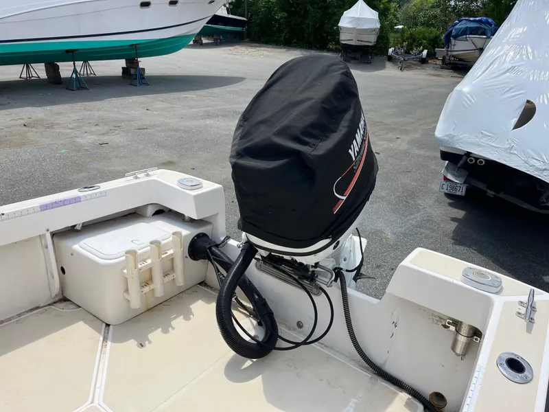 Slide: The Image of 2018 NorthCoast 190 Center Console boat with covered outboard motor in a marina. - 7