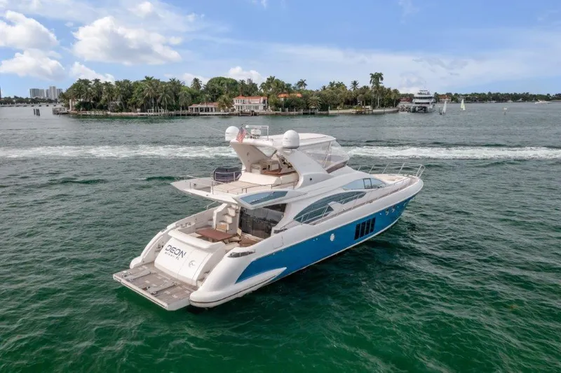 Slide: The Image of 2014 Azimut 64 Flybridge yacht cruising on a scenic waterway. - 15