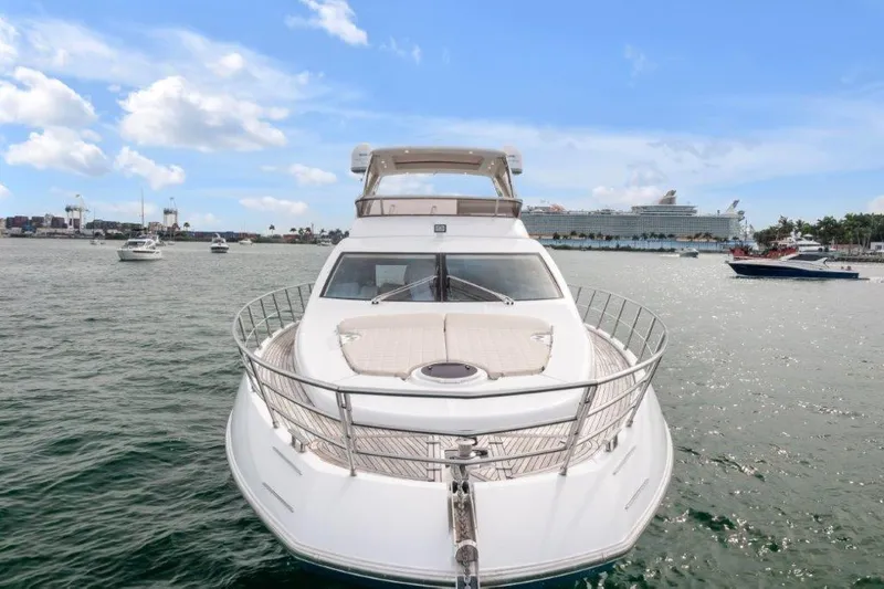 Slide: The Image of Azimut 64 Flybridge 2014 yacht on open water, clear sky, and distant ships. - 2