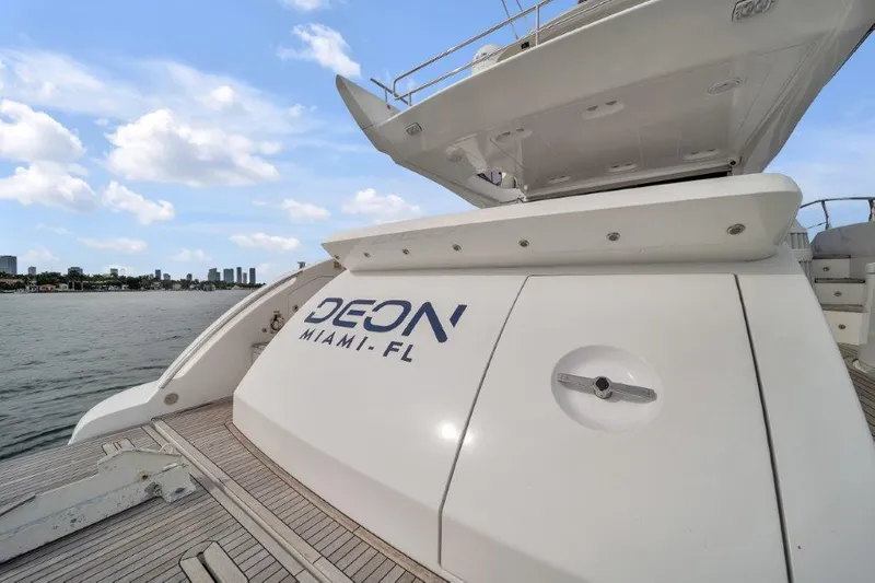 Slide: The Image of 2014 Azimut 64 Flybridge yacht docked in Miami, Florida, with city skyline in background. - 22