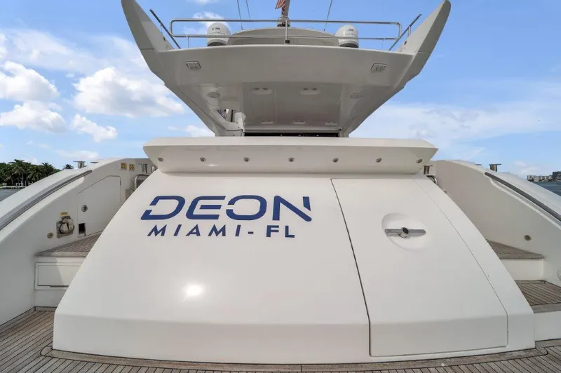 Slide: The Image of Azimut 64 Flybridge 2014 yacht with "DEON MIAMI-FL" text, docked under a clear sky. - 23