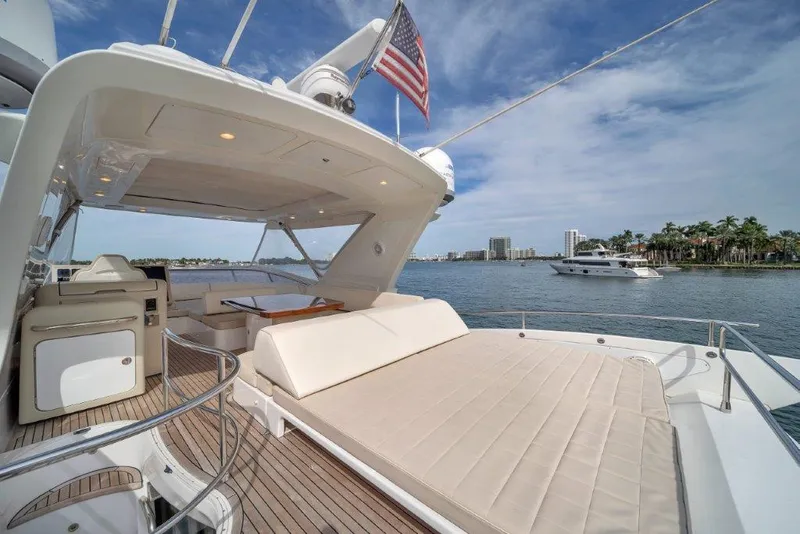Slide: The Image of Luxurious 2014 Azimut 64 Flybridge yacht with spacious deck and scenic waterfront view. - 32
