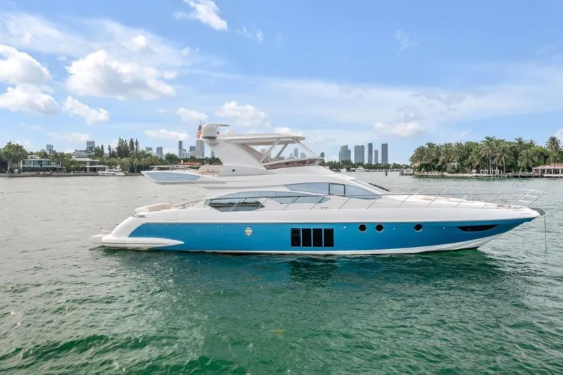 Slide: The Image of Azimut 64 Flybridge 2014 yacht on water with city skyline background. - 4