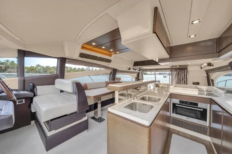 Slide: The Image of Luxurious interior of 2014 Azimut 64 Flybridge yacht with modern kitchen and seating area. - 41