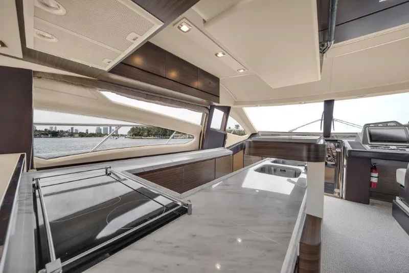 Slide: The Image of Luxurious interior of a 2014 Azimut 64 Flybridge yacht with modern design and panoramic windows. - 47