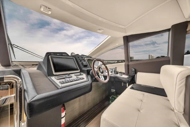 Slide: The Image of Luxurious interior of 2014 Azimut 64 Flybridge yacht cockpit with modern controls and seating. - 48