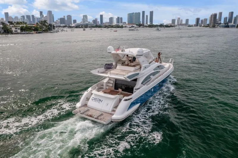 Slide: The Image of Azimut 64 Flybridge 2014 yacht cruising near city skyline on a sunny day. - 8