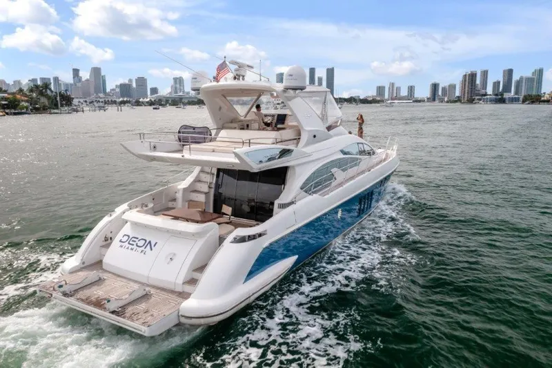 Slide: The Image of Azimut 64 Flybridge 2014 yacht cruising near city skyline on a sunny day. - 9