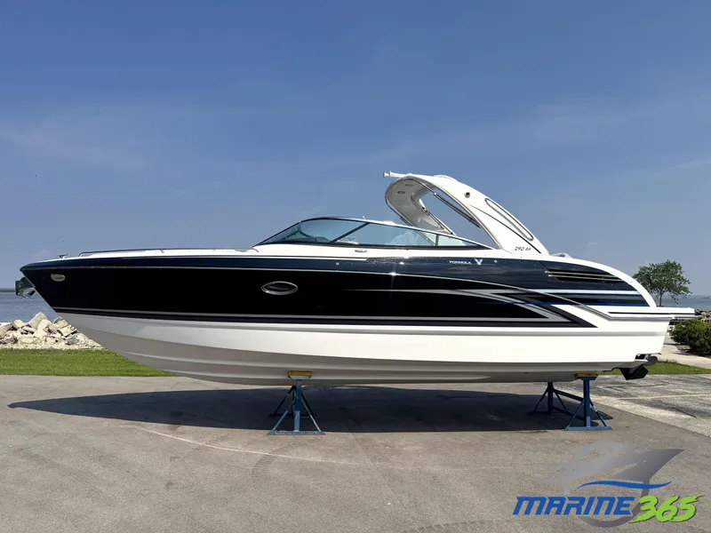 The Image of 2026 Formula 290 Bowrider boat on display, black and white design, parked on stands. - 0