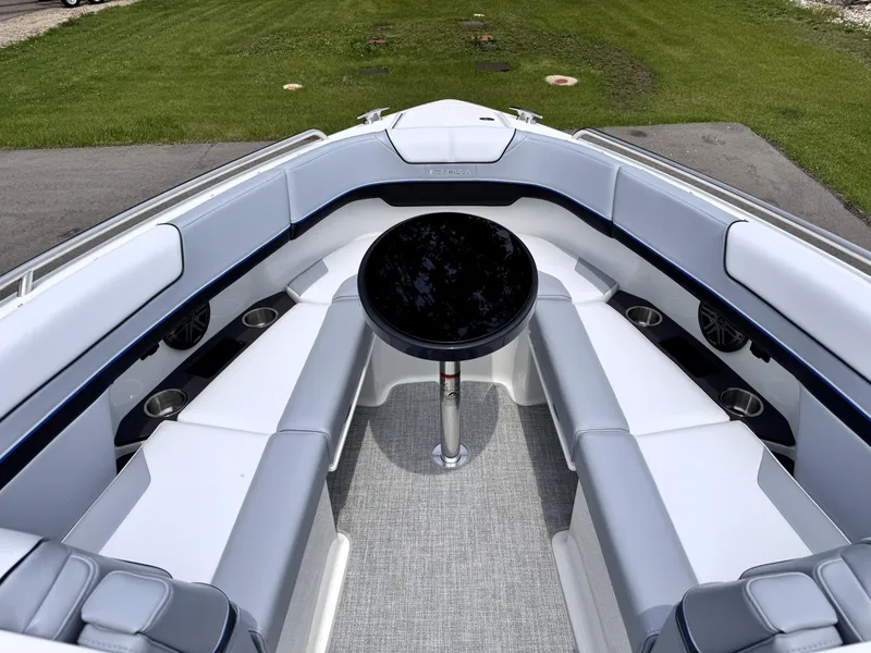 Slide: The Image of 2026 Formula 290 Bowrider interior with sleek seating and central table, parked on grass. - 21