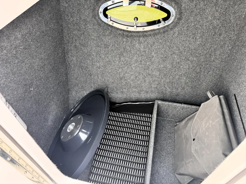 Slide: The Image of Interior storage compartment of 2026 Formula 290 Bowrider boat, featuring carpeted walls and accessories. - 22