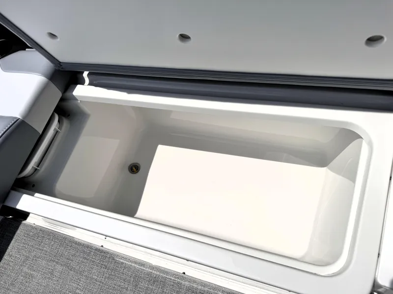Slide: The Image of 2026 Formula 290 Bowrider storage compartment, open lid, spacious interior, white finish. - 23