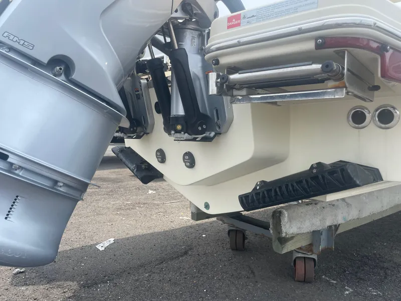 Slide: The Image of 2023 Chris-Craft Calypso 28 boat stern with outboard motor and trailer. - 13