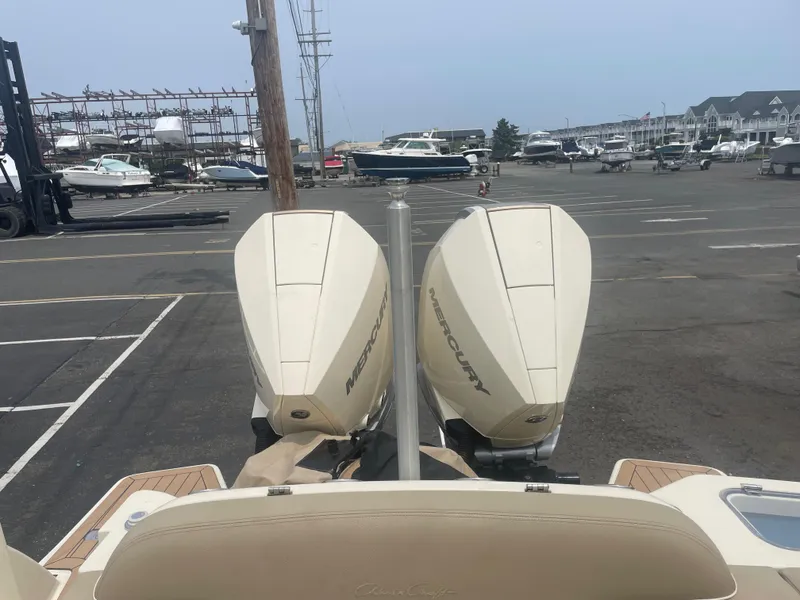 Slide: The Image of 2023 Chris-Craft Calypso 28 with dual Mercury outboard engines at a marina. - 15