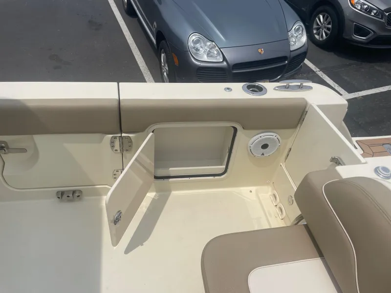 Slide: The Image of 2023 Chris-Craft Calypso 28 boat interior with open storage compartment and seating. - 16