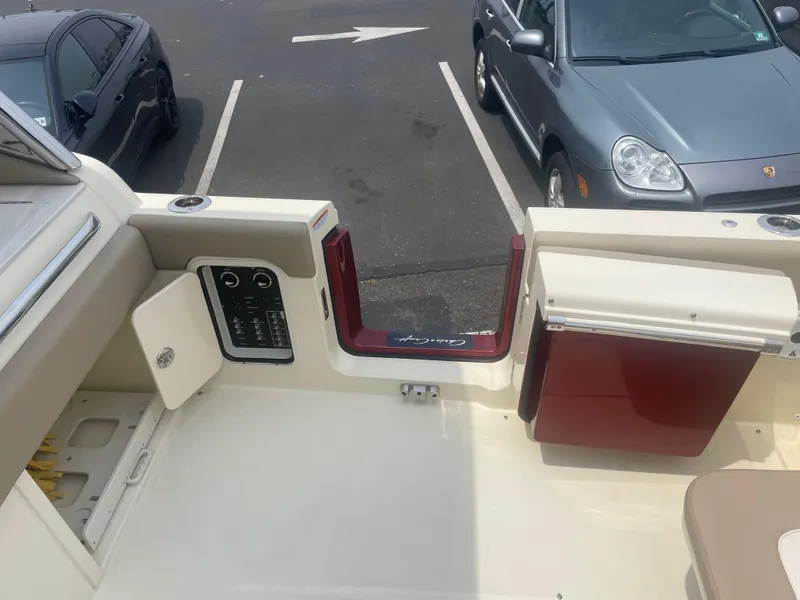 Slide: The Image of 2023 Chris-Craft Calypso 28 boat interior with open storage compartments and seating area. - 18