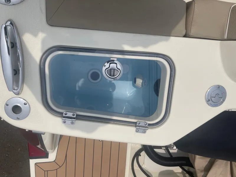 Slide: The Image of 2023 Chris-Craft Calypso 28 boat deck with storage compartment and seating. - 21