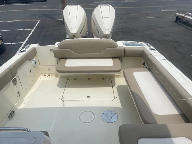 Slide: The Image of 2023 Chris-Craft Calypso 28 boat interior with seating and dual engines. - 23
