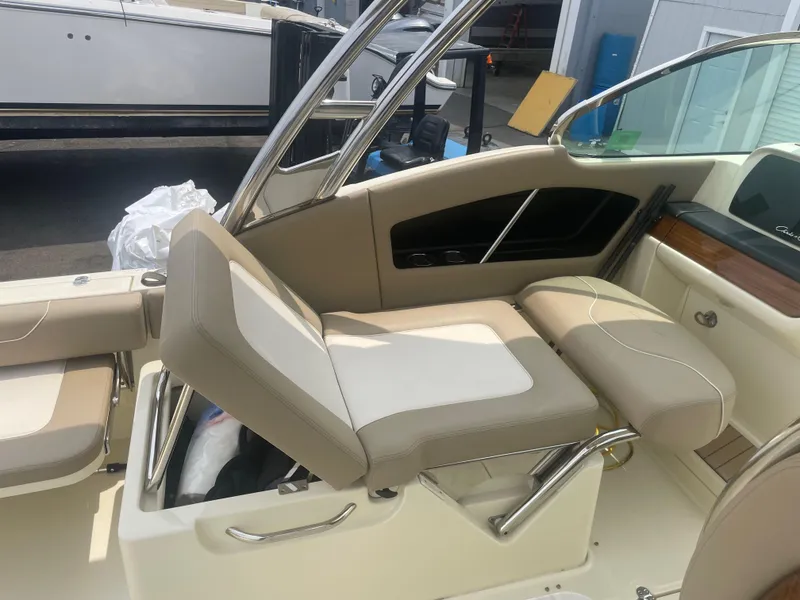 Slide: The Image of 2023 Chris-Craft Calypso 28 boat interior with beige seating and sleek design. - 27