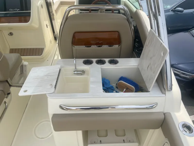Slide: The Image of 2023 Chris-Craft Calypso 28 boat interior with sink and storage area. - 29