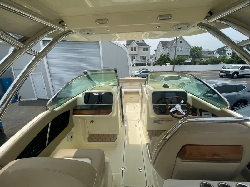 Slide: The Image of 2023 Chris-Craft Calypso 28 boat interior with luxurious seating and modern dashboard. - 30