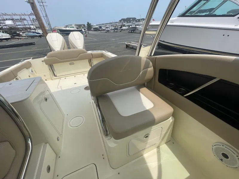 Slide: The Image of 2023 Chris-Craft Calypso 28 boat interior with beige seating and storage compartments. - 33