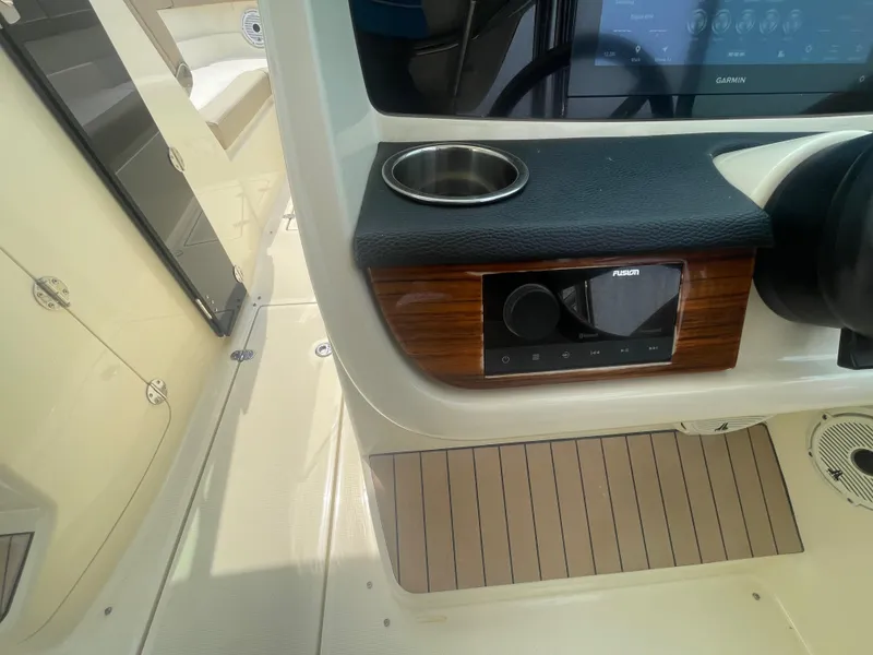 Slide: The Image of 2023 Chris-Craft Calypso 28 dashboard with cup holder and control panel. - 35