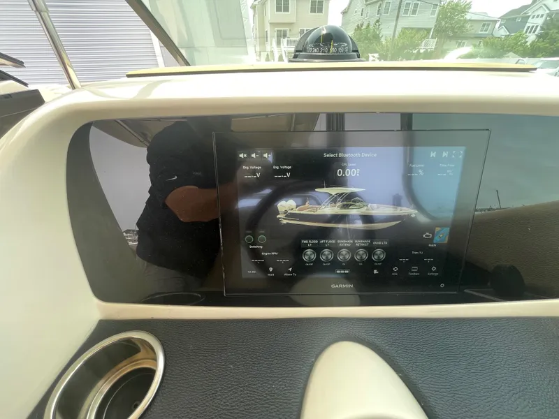 Slide: The Image of 2023 Chris-Craft Calypso 28 dashboard with Garmin display and cup holder. - 36