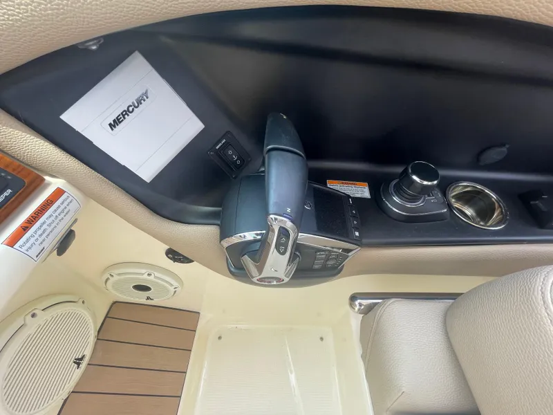 Slide: The Image of 2023 Chris-Craft Calypso 28 boat interior with Mercury controls and beige upholstery. - 37