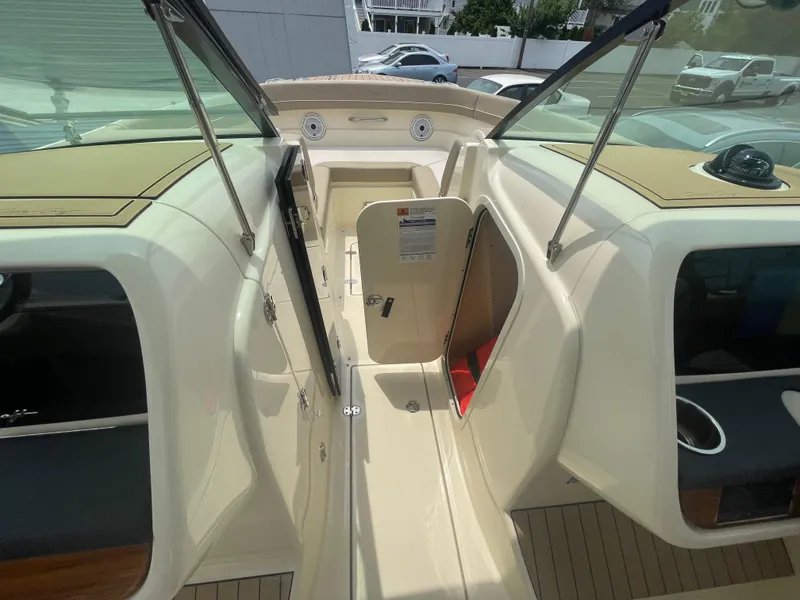 Slide: The Image of 2023 Chris-Craft Calypso 28 boat interior with open cabin door and seating area. - 38