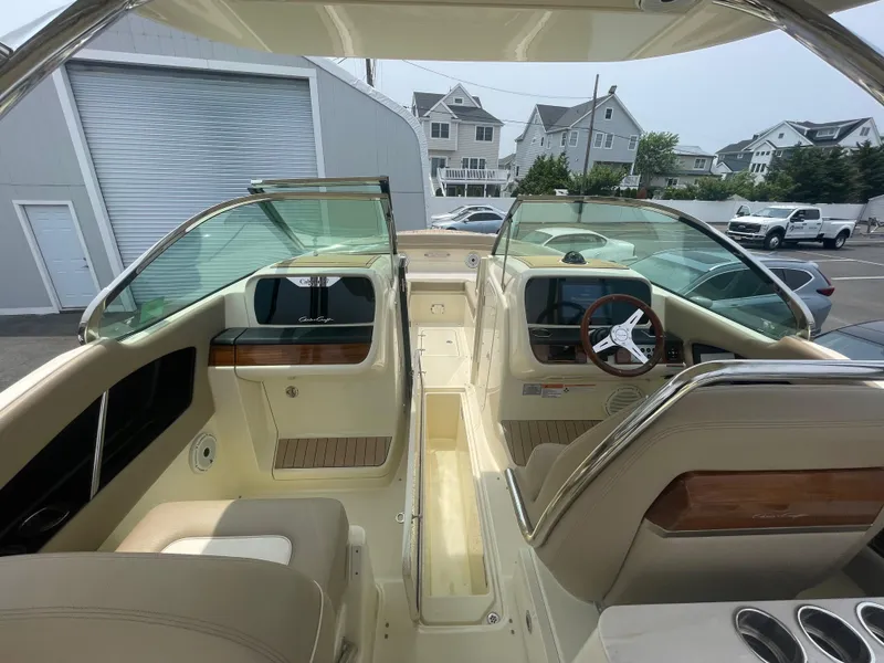 Slide: The Image of 2023 Chris-Craft Calypso 28 boat interior with dual consoles and luxurious seating. - 41