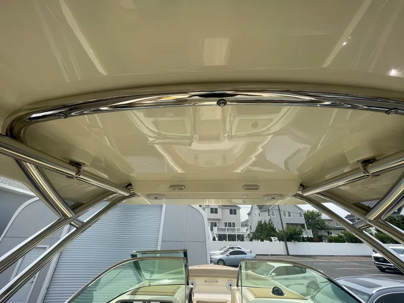 Slide: The Image of 2023 Chris-Craft Calypso 28 boat interior, featuring a sleek, polished roof and modern design elements. - 42
