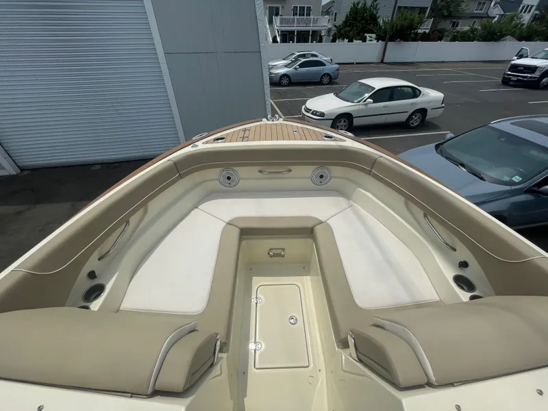Slide: The Image of 2023 Chris-Craft Calypso 28 boat interior with beige seating and storage compartments. - 44