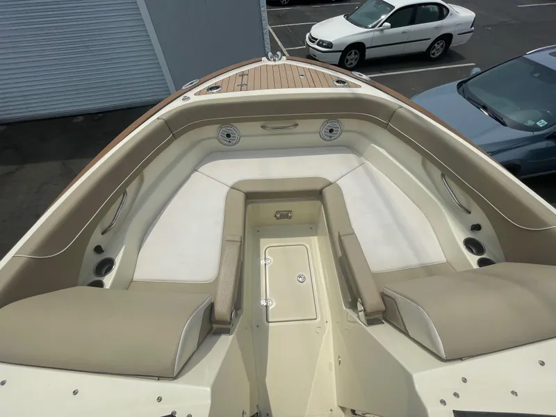 Slide: The Image of 2023 Chris-Craft Calypso 28 boat interior with beige seating and storage compartment. - 45