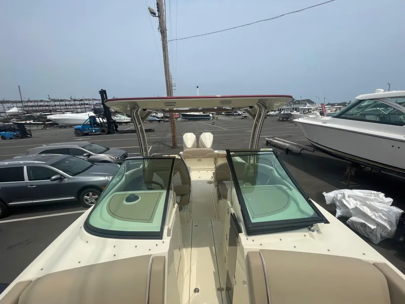 Slide: The Image of 2023 Chris-Craft Calypso 28 boat docked, showcasing sleek design and spacious seating. - 46