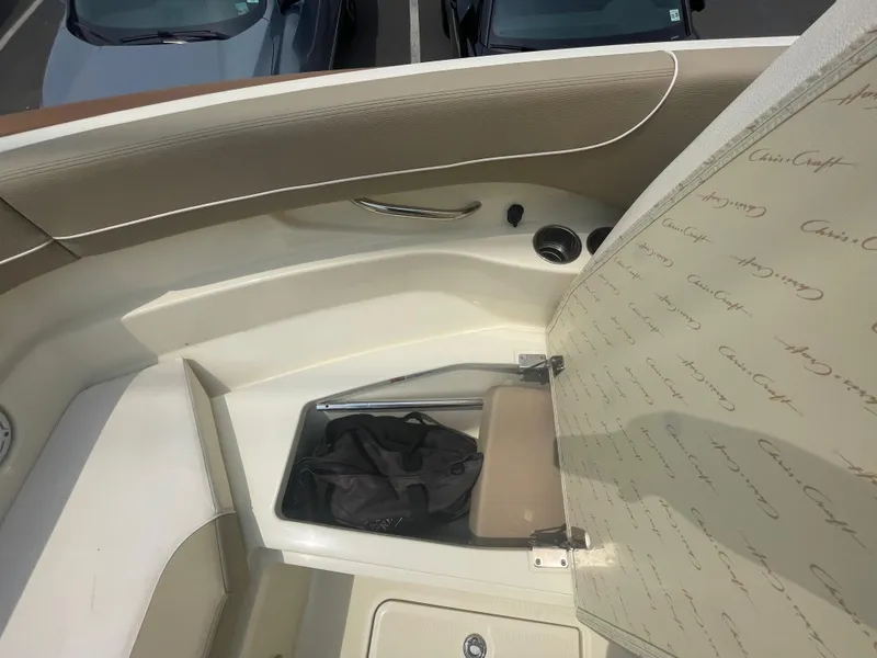 Slide: The Image of 2023 Chris-Craft Calypso 28 boat interior storage compartment with open lid. - 48