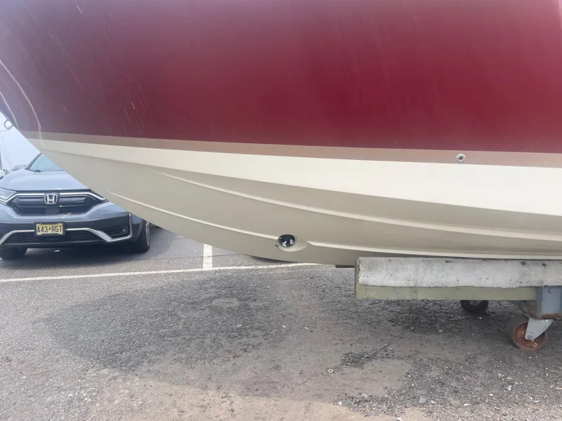 Slide: The Image of 2023 Chris-Craft Calypso 28 boat hull in a parking lot, partial view. - 54