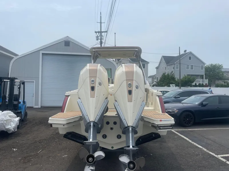 Slide: The Image of 2023 Chris-Craft Calypso 28 with dual outboard engines in a parking lot. - 9