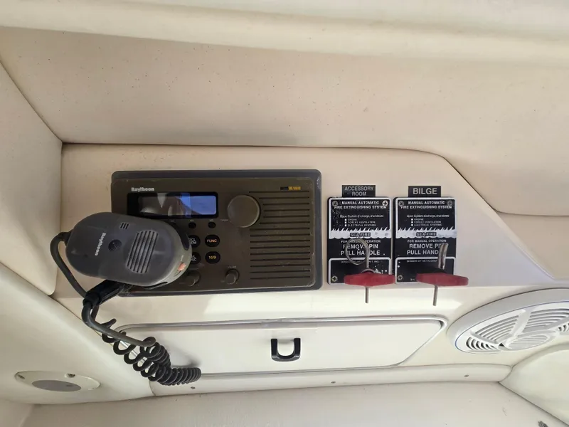 Slide: The Image of Control panel of a 1998 Sea Ray 500 Sundancer boat with radio and bilge switches. - 12