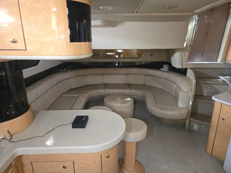 Slide: The Image of Interior of 1998 Sea Ray 500 Sundancer yacht with curved seating and modern amenities. - 15