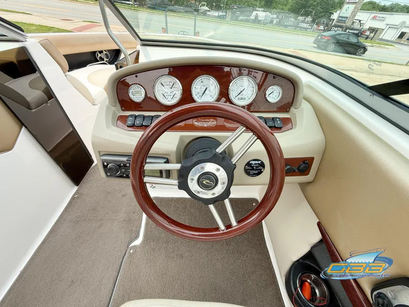Slide: The Image of 2010 Regal 2300 Bowrider dashboard with wood accents and modern gauges. - 13