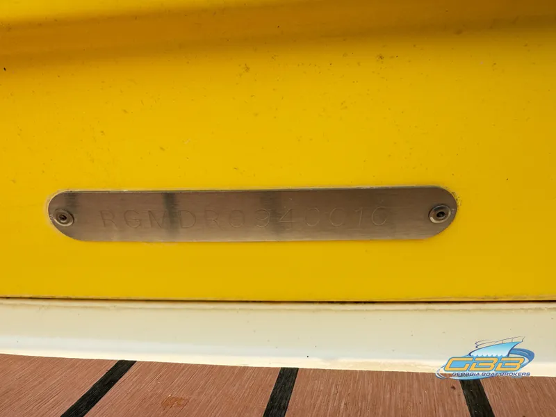 Slide: The Image of Yellow 2010 Regal 2300 Bowrider boat with metal identification plate. - 18