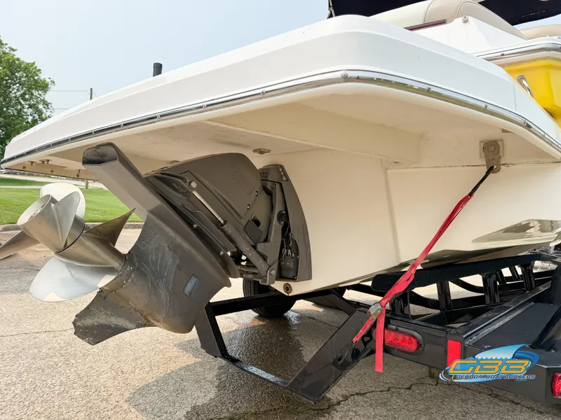 Slide: The Image of 2010 Regal 2300 Bowrider boat on trailer, showing propeller and stern details. - 5