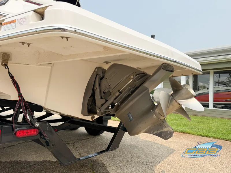 Slide: The Image of 2010 Regal 2300 Bowrider boat stern with dual propellers on a trailer. - 6